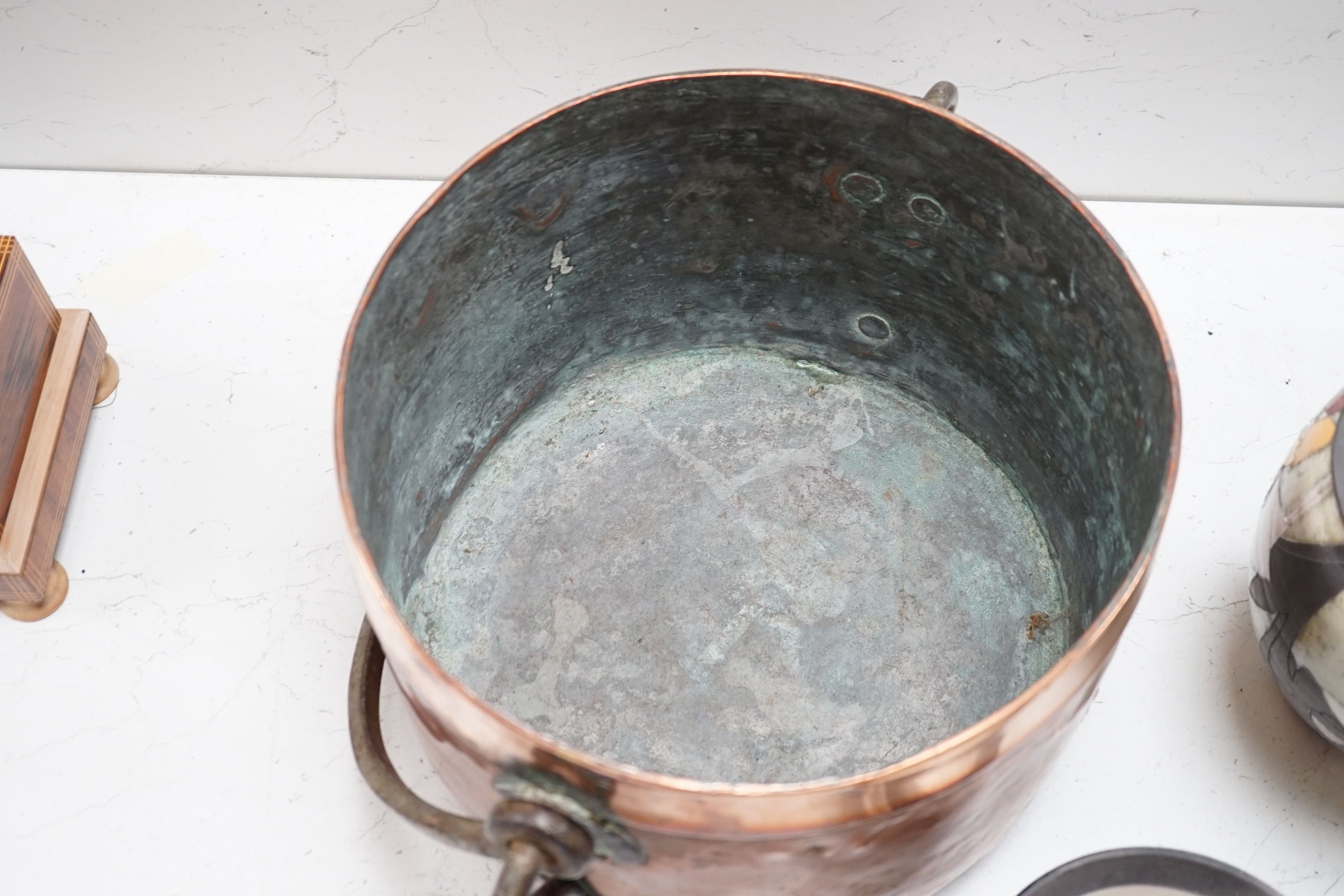 A French copper cooking pot and cover with swing handle, 27cm high